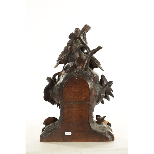 1010 - A 19TH CENTURY BLACK FOREST CARVED LINDEN WOOD MANTEL CLOCK with a family of grouse amongst foliage ... 