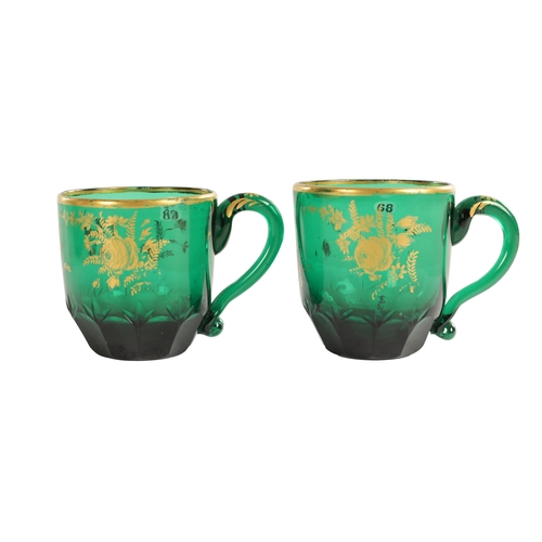 10 - A PAIR OF LATE GEORGIAN BRISTOL GREEN GLASS CUPS IN THE MANNER OF JAMES GILES the facetted and cut l... 