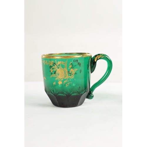 10 - A PAIR OF LATE GEORGIAN BRISTOL GREEN GLASS CUPS IN THE MANNER OF JAMES GILES the facetted and cut l... 