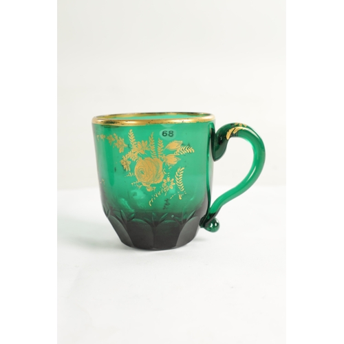 10 - A PAIR OF LATE GEORGIAN BRISTOL GREEN GLASS CUPS IN THE MANNER OF JAMES GILES the facetted and cut l... 