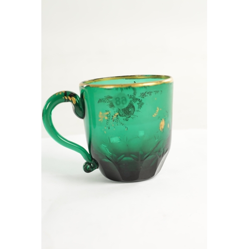 10 - A PAIR OF LATE GEORGIAN BRISTOL GREEN GLASS CUPS IN THE MANNER OF JAMES GILES the facetted and cut l... 