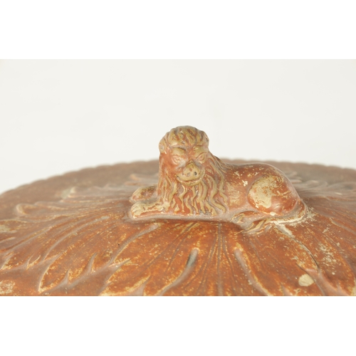 105 - A 19TH CENTURY CONTINENTAL EARTHENWARE TUREEN with leaf moulded and swag work decoration with recumb... 