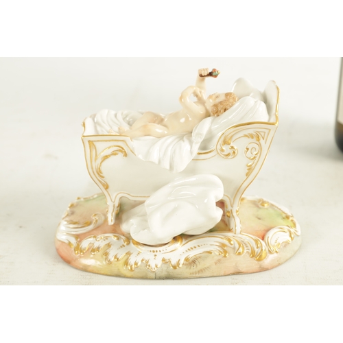 106 - A 19TH CENTURY MEISSEN CRADLE AND CHERUB FIGURE of elaborate design highlighted in gilt and set on a... 