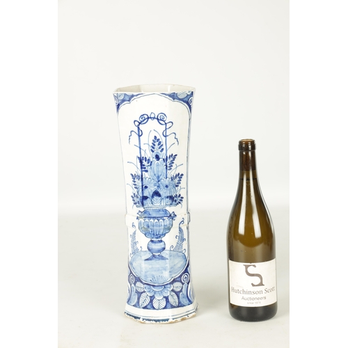 107 - AN EARLY 18TH CENTURY DELFT BLUE AND WHITE CYLINDRICAL VASE of octagonal form decorated with floral ... 