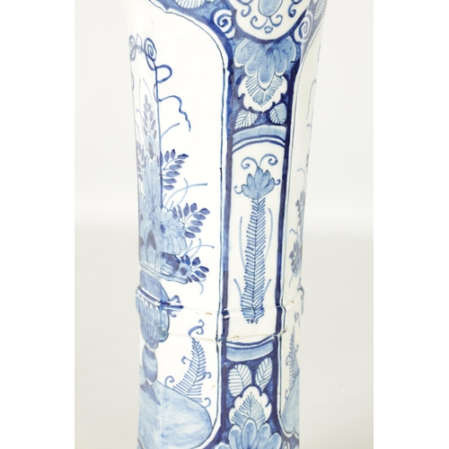 107 - AN EARLY 18TH CENTURY DELFT BLUE AND WHITE CYLINDRICAL VASE of octagonal form decorated with floral ... 