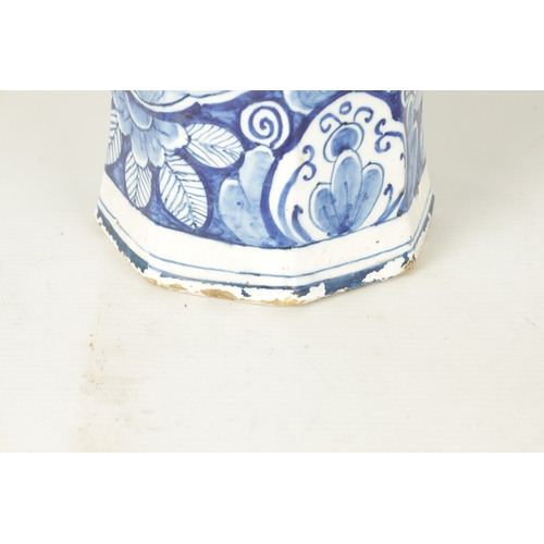 107 - AN EARLY 18TH CENTURY DELFT BLUE AND WHITE CYLINDRICAL VASE of octagonal form decorated with floral ... 