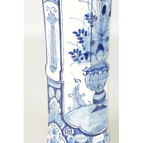 107 - AN EARLY 18TH CENTURY DELFT BLUE AND WHITE CYLINDRICAL VASE of octagonal form decorated with floral ... 