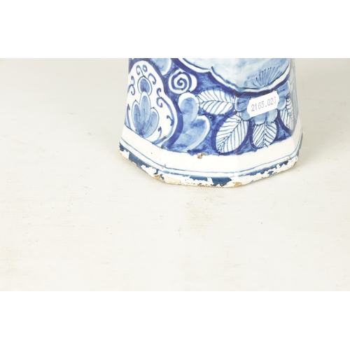 107 - AN EARLY 18TH CENTURY DELFT BLUE AND WHITE CYLINDRICAL VASE of octagonal form decorated with floral ... 