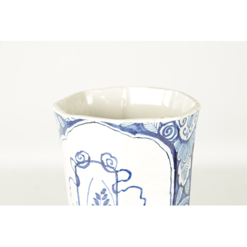 107 - AN EARLY 18TH CENTURY DELFT BLUE AND WHITE CYLINDRICAL VASE of octagonal form decorated with floral ... 