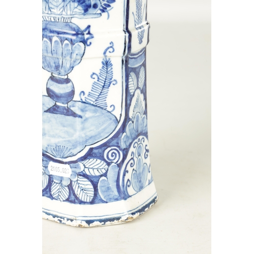 107 - AN EARLY 18TH CENTURY DELFT BLUE AND WHITE CYLINDRICAL VASE of octagonal form decorated with floral ... 