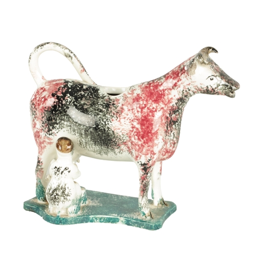 108 - AN EARLY 19TH CENTURY NORTH ENGLAND POTTERY COW CREAMER painted in a red, black and teal mottled pat... 