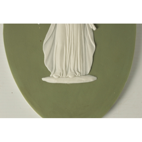 117 - A PAIR OF LATE 19TH CENTURY WEDGWOOD PALE GREEN OVAL JASPER WARE PANELS with raised decoration of cl... 