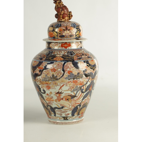 123 - A GOOD PAIR OF 18TH / EARLY 19TH CENTURY JAPANESE IMARI VASES AND COVERS the shouldered ovoid bodies... 