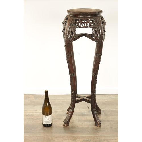 125 - A 19TH CENTURY CHINESE HARDWOOD JARDINIERE STAND with an inset marble top above a faux bamboo carved... 