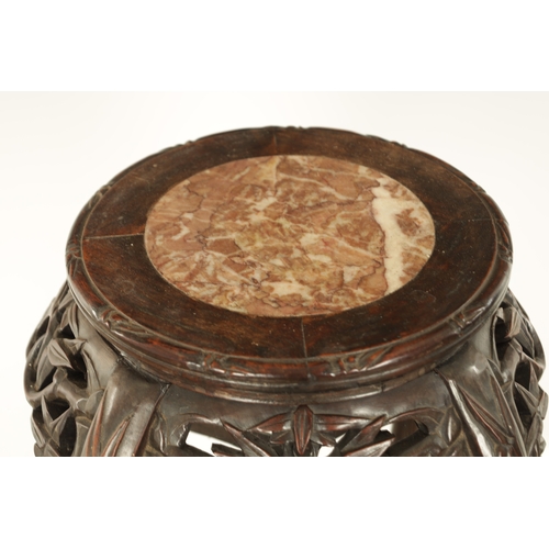 125 - A 19TH CENTURY CHINESE HARDWOOD JARDINIERE STAND with an inset marble top above a faux bamboo carved... 