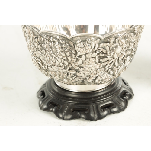 129 - A FINE 19TH CENTURY JAPANESE SILVER BOWL having relief floral decoration - signed underneath, mounte... 