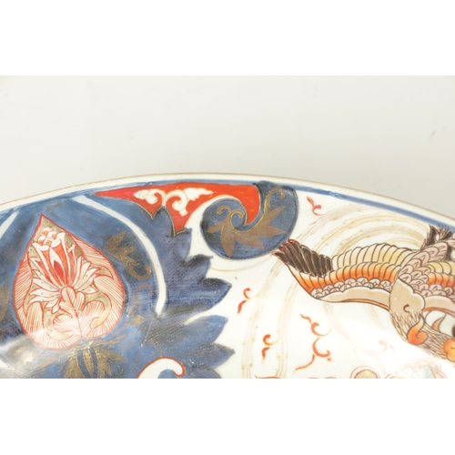 134 - A 17TH CENTURY JAPANESE IMARI CHARGER with polychrome panelled decoration (55cm diameter)