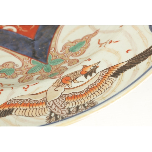 134 - A 17TH CENTURY JAPANESE IMARI CHARGER with polychrome panelled decoration (55cm diameter)