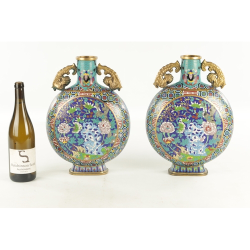 138 - A PAIR OF CHINESE CLOISONNE ENAMEL MOON FLASKS with dragon handles and geometric borders enclosing c... 