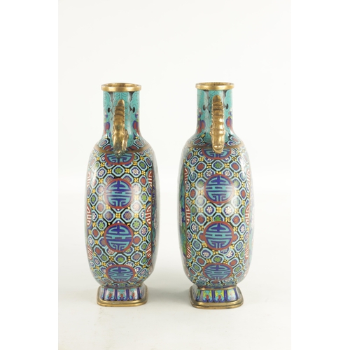 138 - A PAIR OF CHINESE CLOISONNE ENAMEL MOON FLASKS with dragon handles and geometric borders enclosing c... 