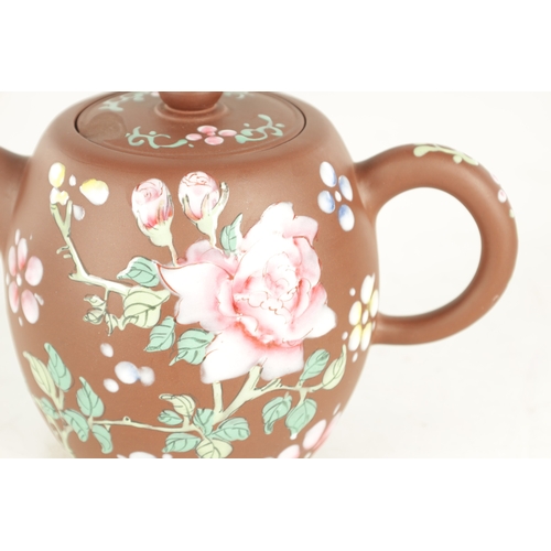 142 - A CHINESE REPUBLIC PERIOD TERRACOTTA TEAPOT with floral applied enamels and impressed mark beneath (... 