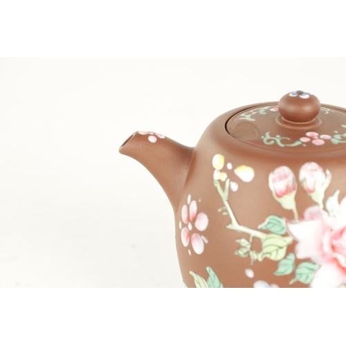 142 - A CHINESE REPUBLIC PERIOD TERRACOTTA TEAPOT with floral applied enamels and impressed mark beneath (... 