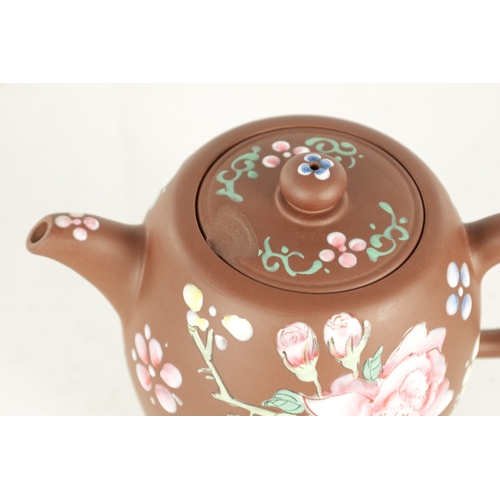 142 - A CHINESE REPUBLIC PERIOD TERRACOTTA TEAPOT with floral applied enamels and impressed mark beneath (... 