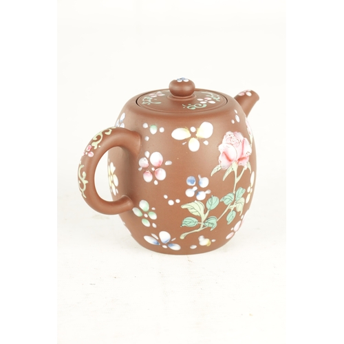 142 - A CHINESE REPUBLIC PERIOD TERRACOTTA TEAPOT with floral applied enamels and impressed mark beneath (... 