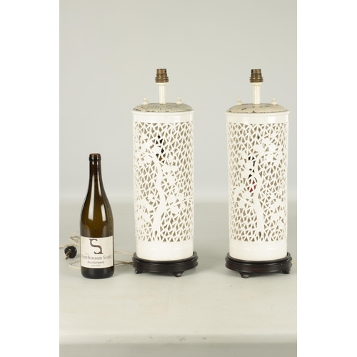 143 - A PAIR OF 20TH CENTURY CHINESE BLANC DE CHINE TABLE LAMPS decorated with pierced bamboo bodies on ha... 