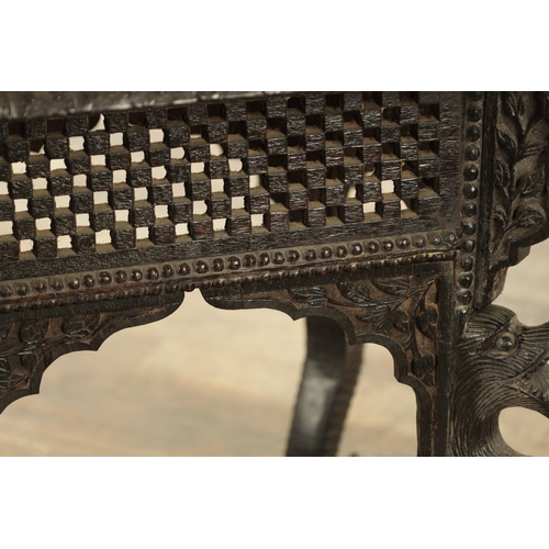 149 - A LATE 19TH CENTURY ANGLO INDIAN TWO TIER HARDWOOD OCCASIONAL TABLE the carved square top with centr... 