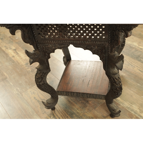 149 - A LATE 19TH CENTURY ANGLO INDIAN TWO TIER HARDWOOD OCCASIONAL TABLE the carved square top with centr... 