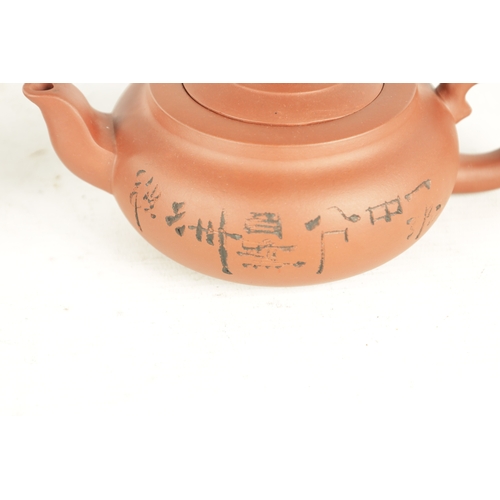 150 - TWO CHINESE TERRACOTTA TEAPOTS squat form bodies and shaped handles, lift-off lids one with foo dog ... 