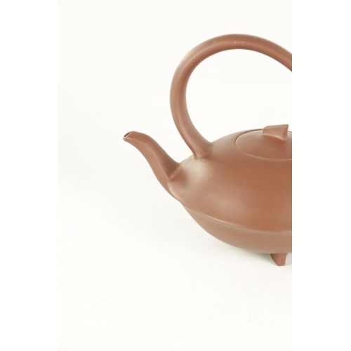 154 - TWO CHINESE TERRACOTTA TEAPOTS with slim saucer-shaped bodies and shaped handles and lift-off fin ha... 