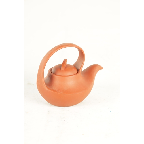 154 - TWO CHINESE TERRACOTTA TEAPOTS with slim saucer-shaped bodies and shaped handles and lift-off fin ha... 