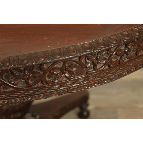 159 - A LARGE EARLY 19TH CENTURY INDIAN HARDWOOD CENTRE TABLE with carved floral frieze raised on a bulbou... 