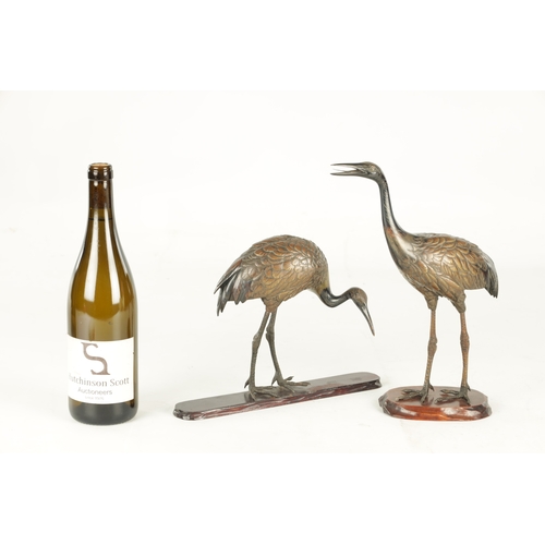 160 - A GOOD PAIR OF JAPANESE MEIJI PERIOD COLD PAINTED BRONZE SCULPTURES OF CRANES on hardwood bases (one... 