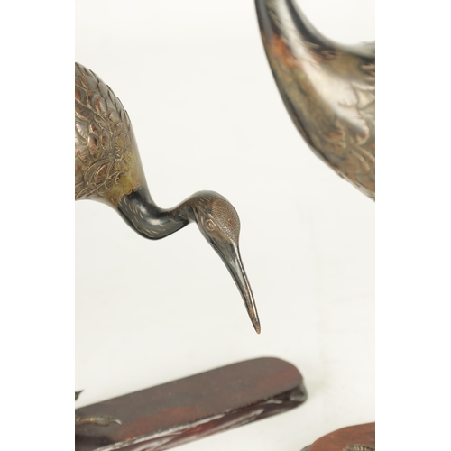 160 - A GOOD PAIR OF JAPANESE MEIJI PERIOD COLD PAINTED BRONZE SCULPTURES OF CRANES on hardwood bases (one... 