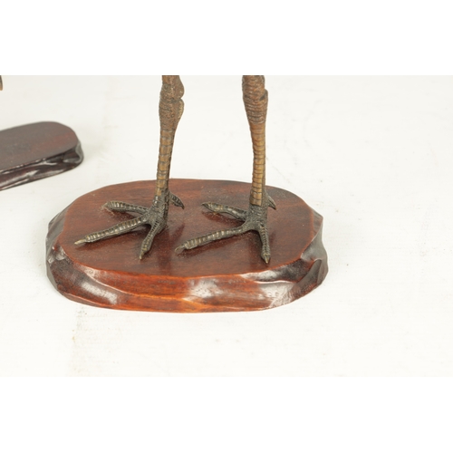 160 - A GOOD PAIR OF JAPANESE MEIJI PERIOD COLD PAINTED BRONZE SCULPTURES OF CRANES on hardwood bases (one... 