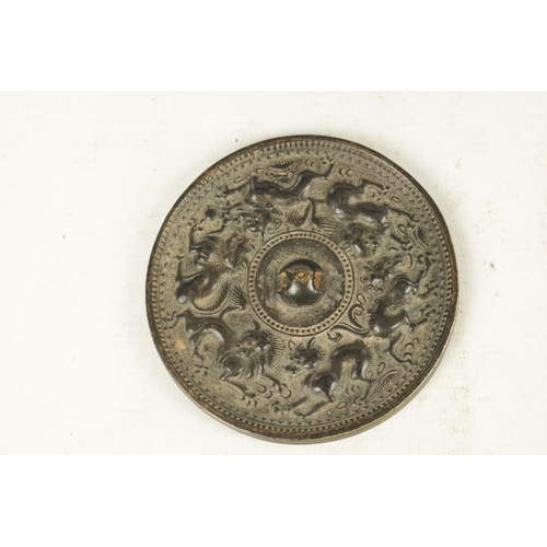 167 - A COLLECTION OF THREE EARLY CHINESE BRONZE MIRRORS of circular form with cast relief decoration. (13... 