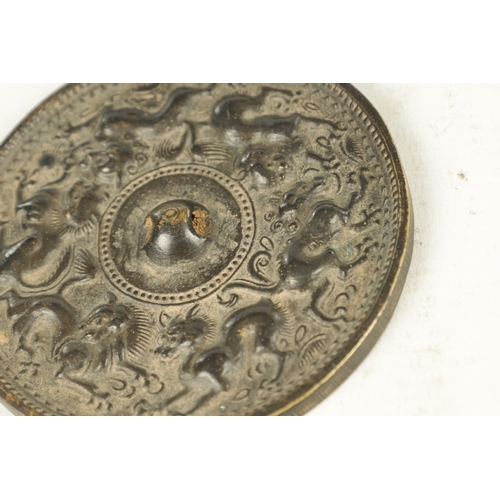 167 - A COLLECTION OF THREE EARLY CHINESE BRONZE MIRRORS of circular form with cast relief decoration. (13... 