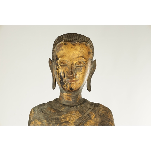 168 - AN EARLY GILT BRONZE BURMESE STANDING BUDDHA mounted on a later ebonised stand (buddha 76cm high 93c... 