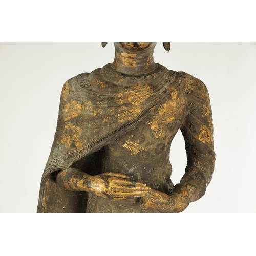 168 - AN EARLY GILT BRONZE BURMESE STANDING BUDDHA mounted on a later ebonised stand (buddha 76cm high 93c... 