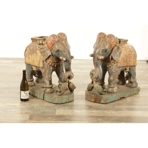 171 - A LARGE PAIR OF 19TH CENTURY INDIAN CARVED POLYCHROME PAINTED SCULPTURES OF ELEPHANTS mounted on ova... 