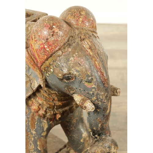 171 - A LARGE PAIR OF 19TH CENTURY INDIAN CARVED POLYCHROME PAINTED SCULPTURES OF ELEPHANTS mounted on ova... 