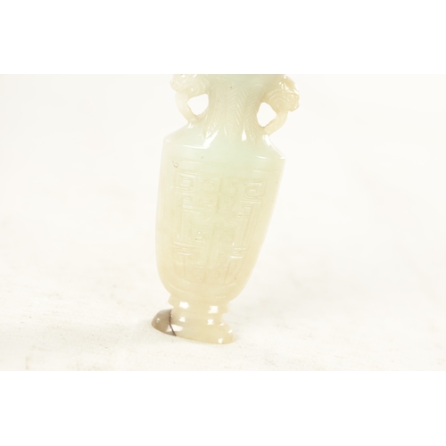 180 - A GOOD 19TH CENTURY CHINESE CARVED WHITE JADE SNUFF BOTTLE formed as an urn with foo dog side handle... 