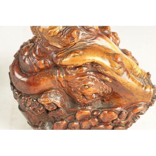 188 - A FINE 19TH CENTURY PATINATED CALVED ROOTWOOD SCULPTURE depicting a pagoda landscape view, seated ch... 