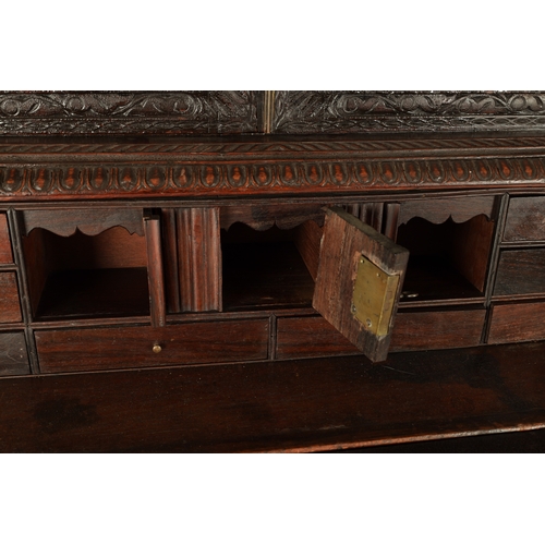 194 - AN EARLY 19TH CENTURY ANGLO INDIAN HARDWOOD SECRETAIRE CABINET ON CHEST with moulded cornice above a... 