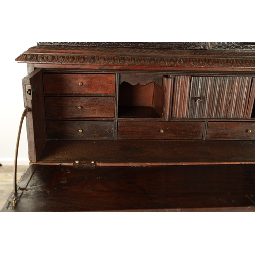 194 - AN EARLY 19TH CENTURY ANGLO INDIAN HARDWOOD SECRETAIRE CABINET ON CHEST with moulded cornice above a... 