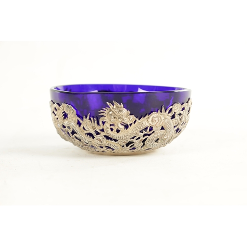 195 - A 19TH CENTURY CHINESE SILVER MOUNTED BLUE SMALL GLASS BOWL with all-around entwined dragon decorati... 