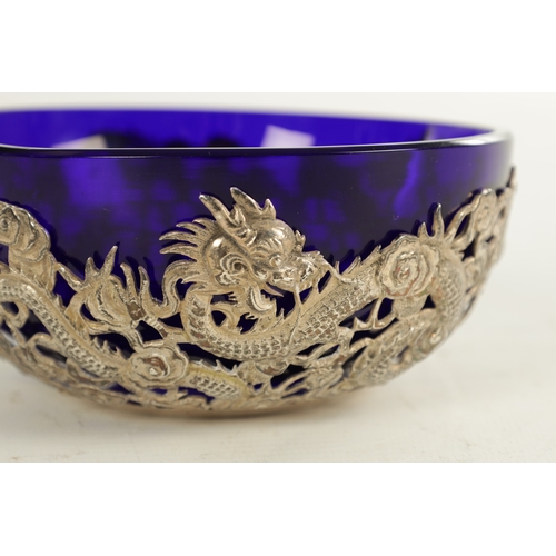 195 - A 19TH CENTURY CHINESE SILVER MOUNTED BLUE SMALL GLASS BOWL with all-around entwined dragon decorati... 